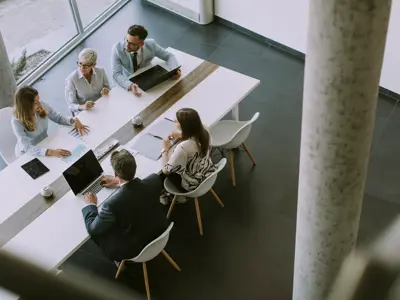 Arial view of employees at a communal desk 